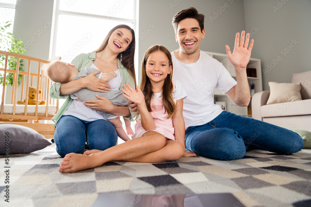 Photo of charming friendly husband wife little children tacking selfie waving arms smiling indoors room home house