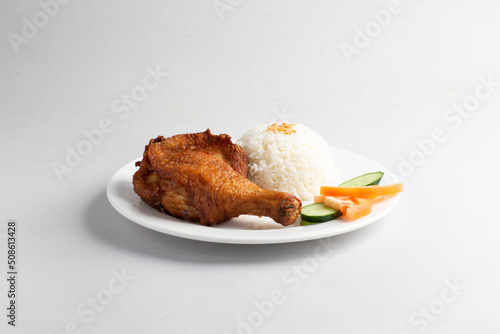 asian deep fried fresh crispy kampong chicken rice with cucumber and tomato in white background halal menu