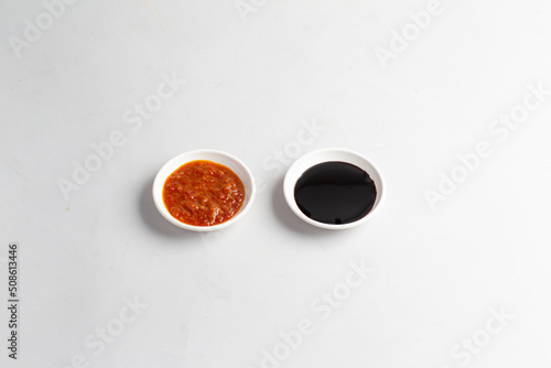 asian chicken rice spicy chilli sauce with thick dark sweet black soya sauce in white background halal sauce