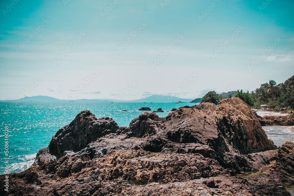 landscape of rocks and sea waves turquoise green sea background. Beautiful water view on a Summer Day. landscape of rocks and sea waves turquoise green sea background. Beautiful water view on a Summer Day.