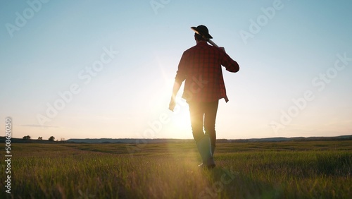 Fototapeta Naklejka Na Ścianę i Meble -  agriculture. farmer with a shovel walk in the field. agriculture business harvesting portrait of a farmer man with shovel a walk to work in the field. business natural products sun harvest soil