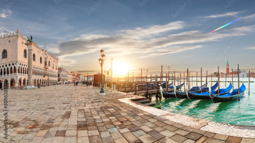 Doge's Palace and gondolas pier near San Marco Square at sunrise, Venice, Italy