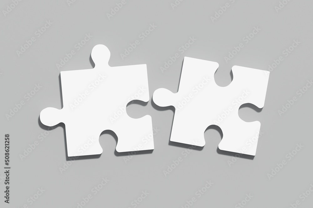 Two white puzzles on a gray background, the concept of joining or separating something Two white puzzles on a gray background, the concept of joining or separating something