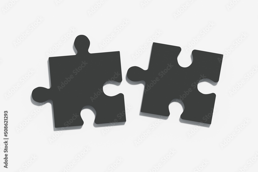 Two black puzzles on a light grey background, the concept of joining or separating something Two black puzzles on a light grey background, the concept of joining or separating something
