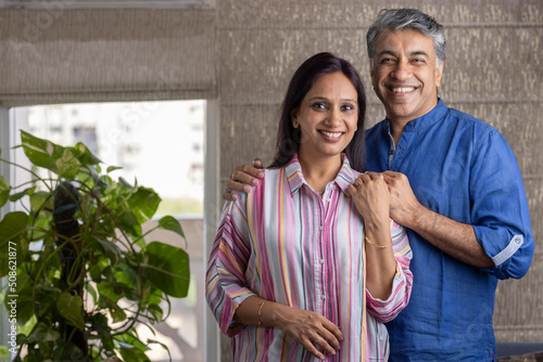 Happy mature couple spending leisure time together at home photo