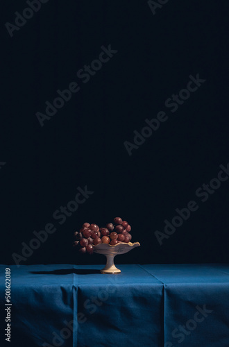 red grapes on a table with blue tablecloth