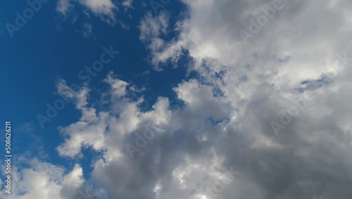 TimeLapse blue sunny sky, loop of white clouds. Summer blue sky.