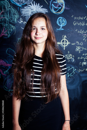 back to school after summer vacations, cute teen girl in classroom