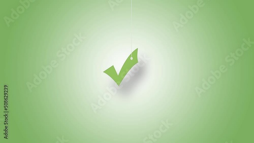 OK sign in green hanged with strings against green background. High quality video in 4K resolution.