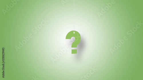Question mark in green hanged with strings against green background. High quality video in 4K resolution.