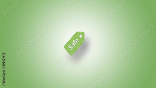 Price tag in green hanged with strings against green background. High quality video in 4K resolution.