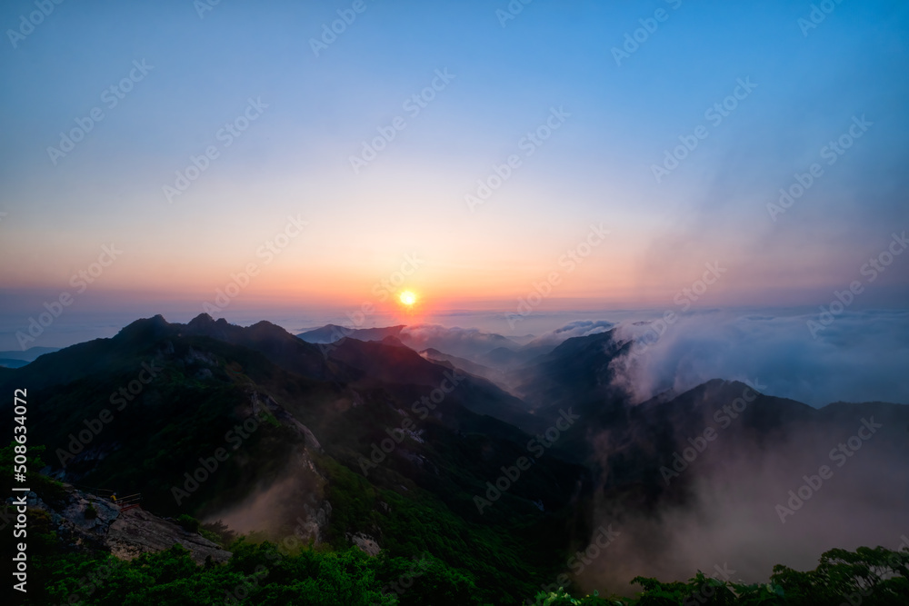 Scenic view of mountains against sky during sunrise Scenic view of mountains against sky during sunrise