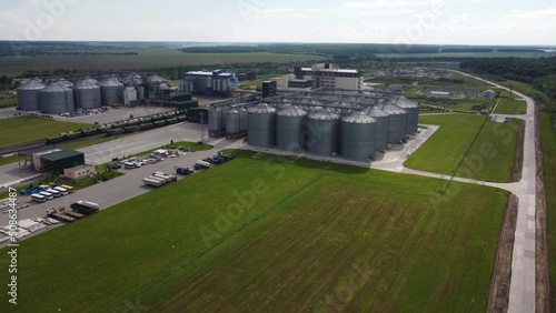 long rows of huge white gas tanks connected with pipeline system at refinery plant on sunny day aerial view