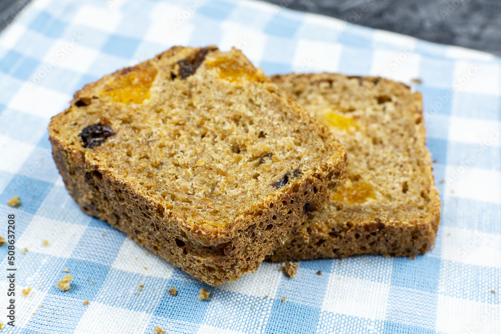 Two pieces of whole-grain sprouted grain bread with dried fruits (dried apricots, prunes) on a napkin close-up. Healthy lifestyle. Proper nutrition.