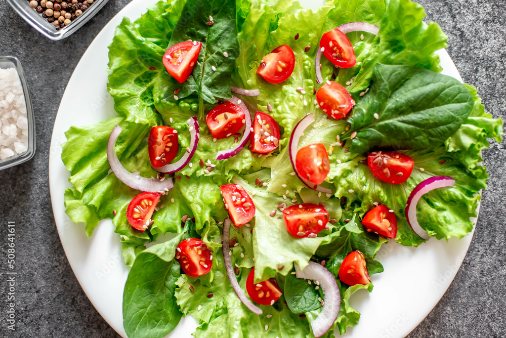 Green vegan salad from vegetables and green ,leaves mix on stone background.Healthy food. Green vegan salad from vegetables and green ,leaves mix on stone background.Healthy food.