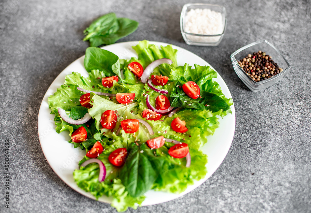 Green vegan salad from vegetables and green ,leaves mix on stone background.Healthy food.
