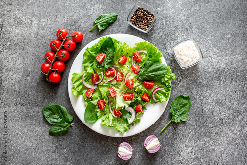 Green vegan salad from vegetables and green ,leaves mix on stone background.Healthy food.