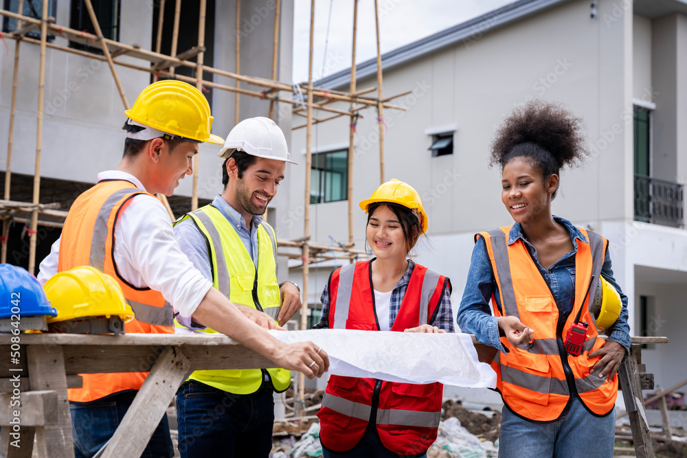 group civil engineers male female discuss inspect construction of houses in the village who responsible for exterior work build houses according standards to strong correct according designed designs group civil engineers male female discuss inspect construction of houses in the village who responsible for exterior work build houses according standards to strong correct according designed designs