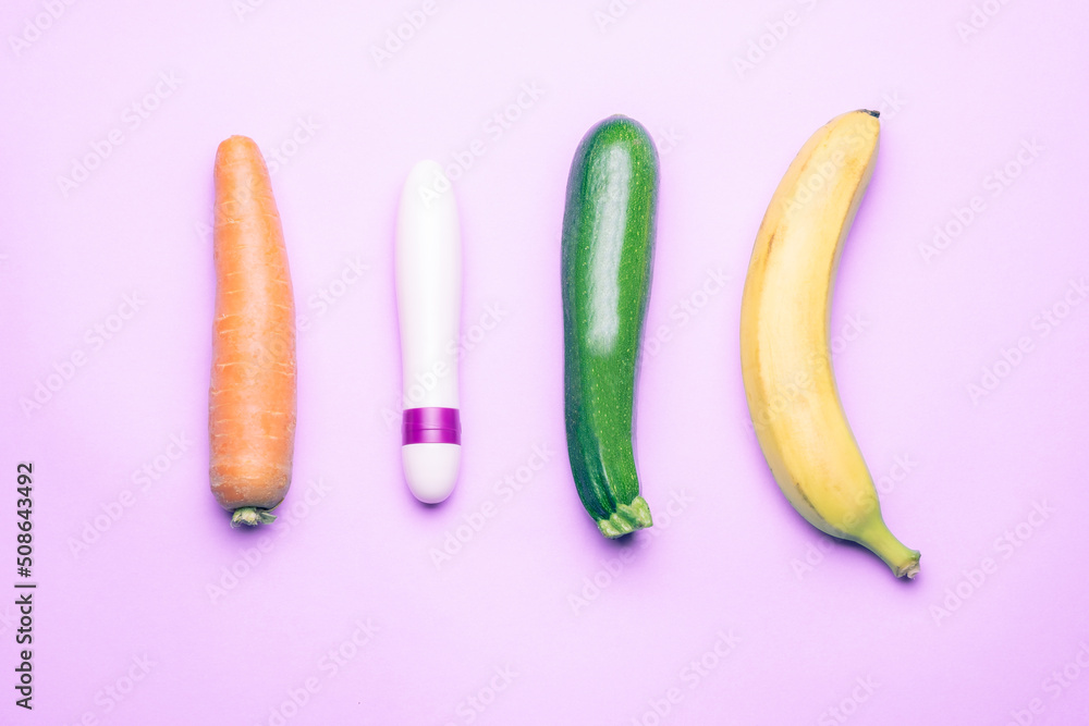 female dildo with phallic shaped vegetables on a light purple background photographed from above and horizontally female dildo with phallic shaped vegetables on a light purple background photographed from above and horizontally
