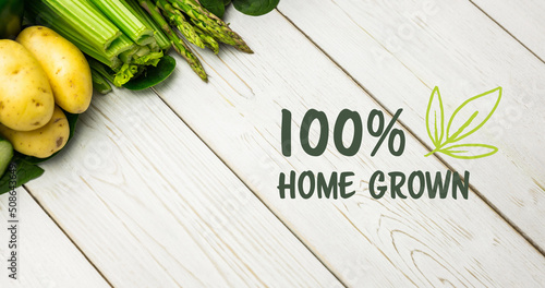 Image of home grown text in green over fresh organic vegetables on wooden boards