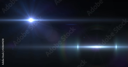Image of two beams of white light moving across dark background