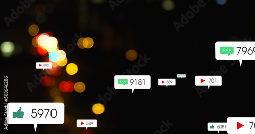 Image of social media icons and numbers over out of focus traffic lights