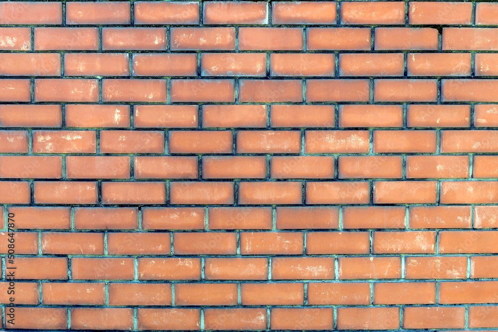 Obraz premium The background is made of a brick wall made of red bricks.