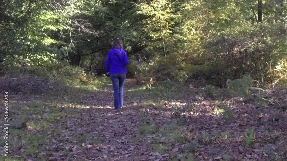 Young girl walking in Savernake Forest - England Young girl walking in Savernake Forest - England