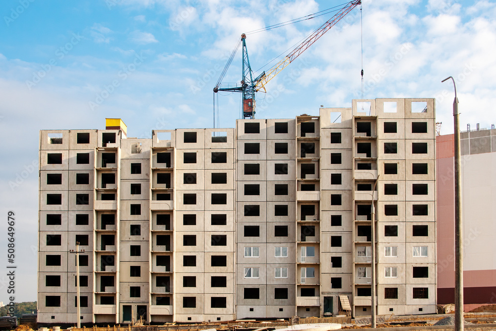 Fototapeta premium Construction of a residential building made of concrete blocks. View of the facade of an unfinished building.