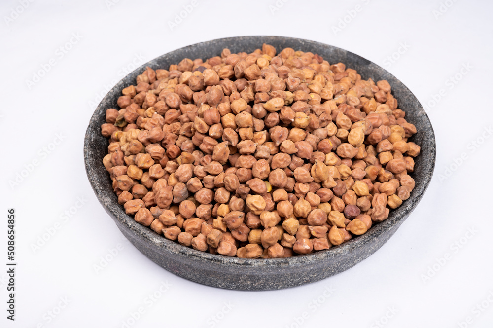 chickpeas (Bengal Gram) in rock bowl on white background. Close up of Organic chana or chickpea (Cicer arietinum). for design and banner. top view chickpeas. chickpeas (Bengal Gram) in rock bowl on white background. Close up of Organic chana or chickpea (Cicer arietinum). for design and banner. top view chickpeas.