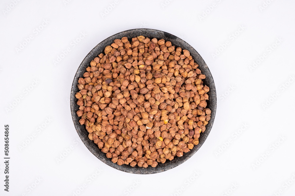 chickpeas (Bengal Gram) in rock bowl on white background. Close up of Organic chana or chickpea (Cicer arietinum). for design and banner. top view chickpeas. chickpeas (Bengal Gram) in rock bowl on white background. Close up of Organic chana or chickpea (Cicer arietinum). for design and banner. top view chickpeas.