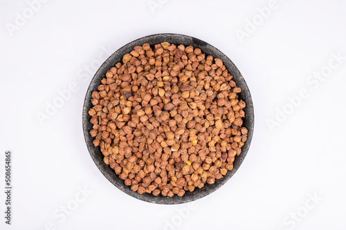 chickpeas (Bengal Gram) in rock bowl on white background. Close up of Organic chana or chickpea (Cicer arietinum). for design and banner. top view chickpeas. photo