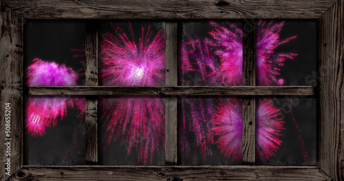 Image of window with pink christmas and new year fireworks in night sky