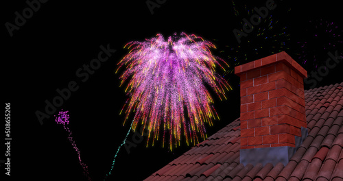 Image of roof and chimney with colourful christmas and new year fireworks exploding in night sky