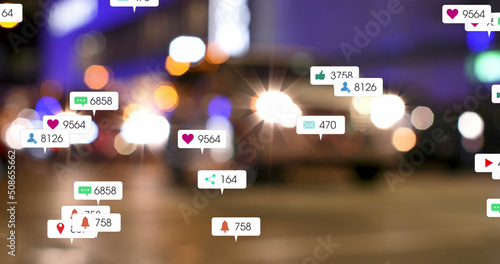Image of social media icons and numbers over out of focus traffic light