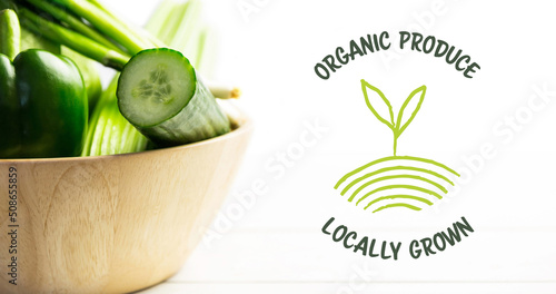 Image of organic produce text in green over fresh organic vegetable salad in bowl on white