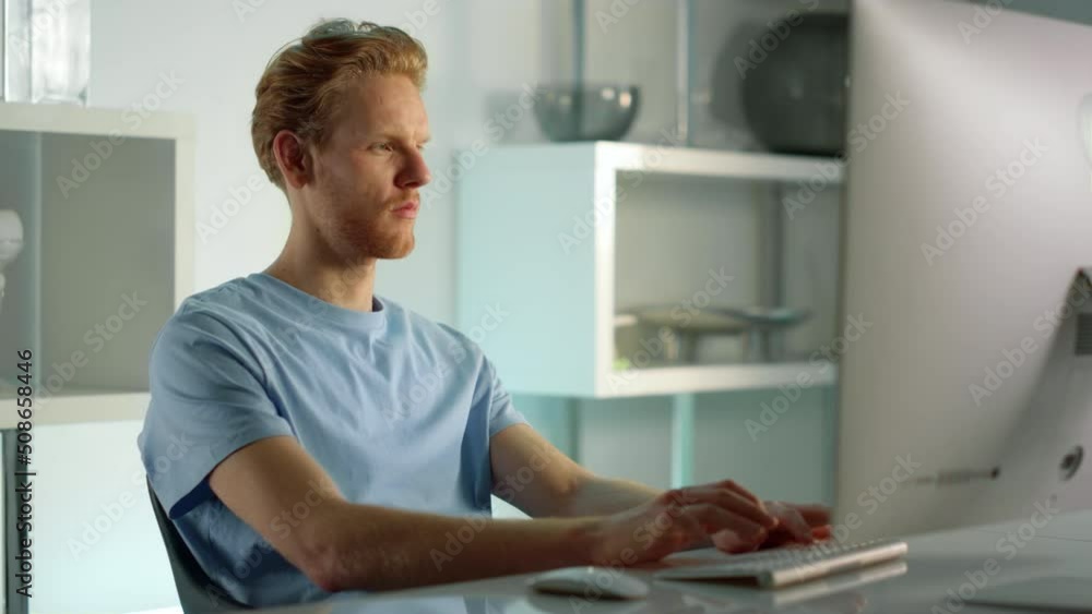 Student working studying home closeup. Confident ginger man writing check email. Student working studying home closeup. Confident ginger man writing check email.