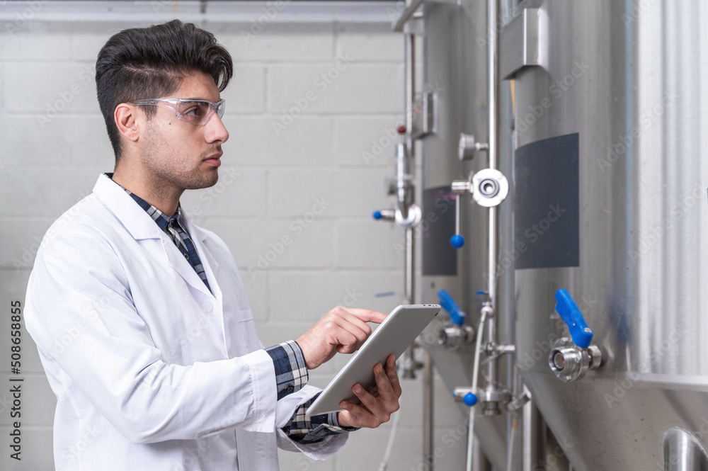 Work in modern brewery, data collection and production monitoring. High quality photography. Work in modern brewery, data collection and production monitoring. High quality photography.