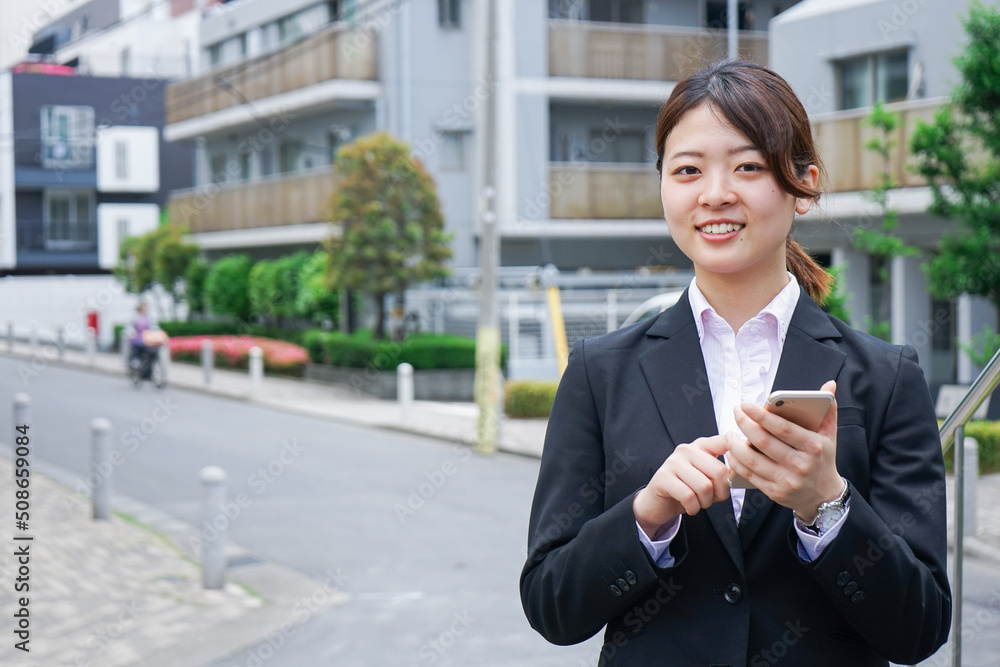 Young businesswoman searching for a destination with her smartphone Young businesswoman searching for a destination with her smartphone