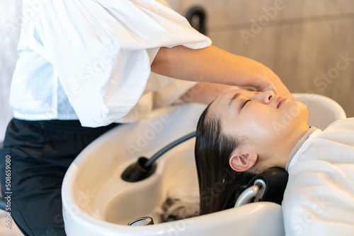 A hairdresser shampooing a customer