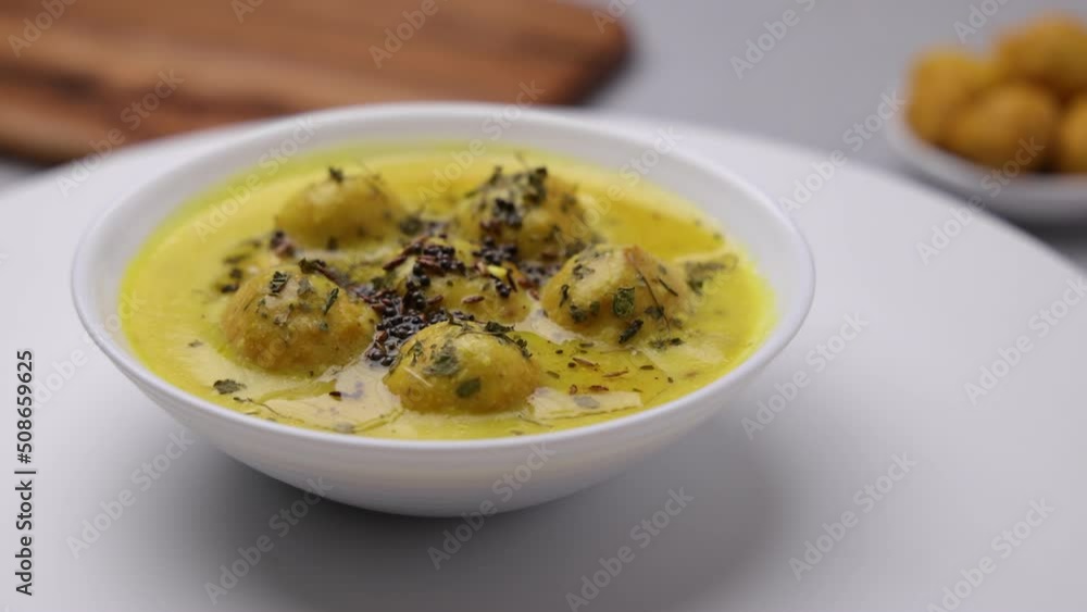 Kadi Pakoda served in a a white shallow plate Kadi Pakoda served in a a white shallow plate