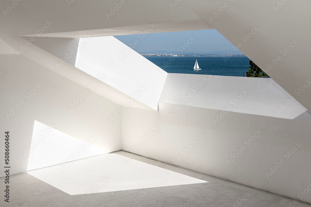 Fototapeta premium Window outlook under the roof on blue sky and sea with white sailing boat.