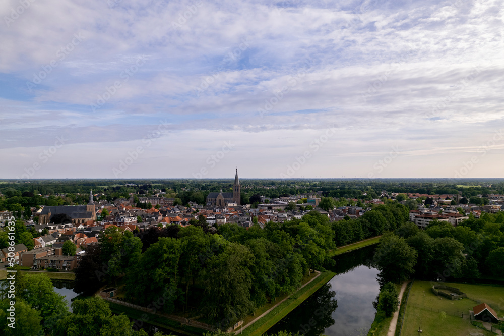 Aerial view of historic Dutch city Groenlo with church tower rising above the authentic medieval rooftops and defending moat in  the foreground