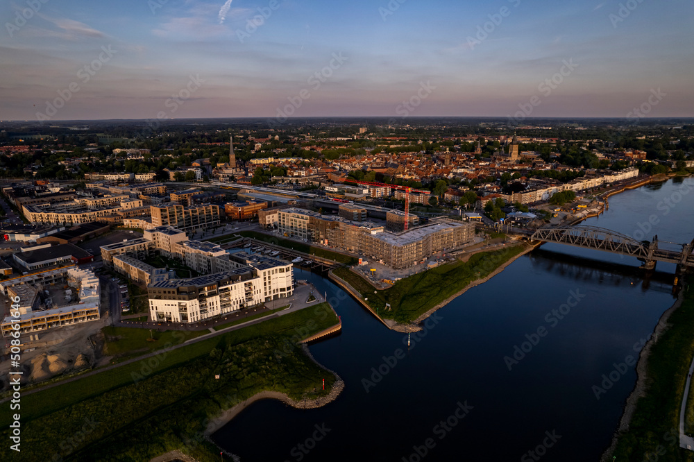 Luxury apartment complex construction at riverbank of river IJssel between train tracks and recreational port. Aerial panorama of the new Kade Zuid residential urban housing project Luxury apartment complex construction at riverbank of river IJssel between train tracks and recreational port. Aerial panorama of the new Kade Zuid residential urban housing project