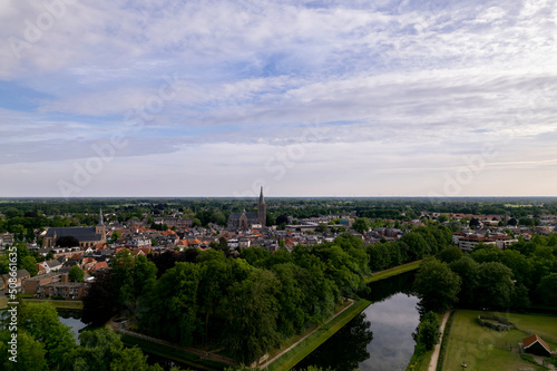 Aerial view of historic Dutch city Groenlo with church tower rising above the authentic medieval rooftops and defending moat in the foreground