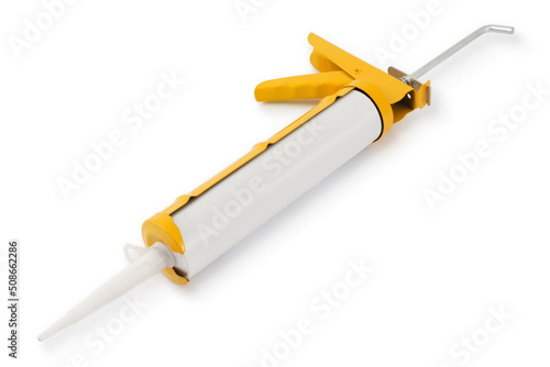 Silicone sealant gun, tool for construction or industrial works, colored in yellow isolated on white background.. photo