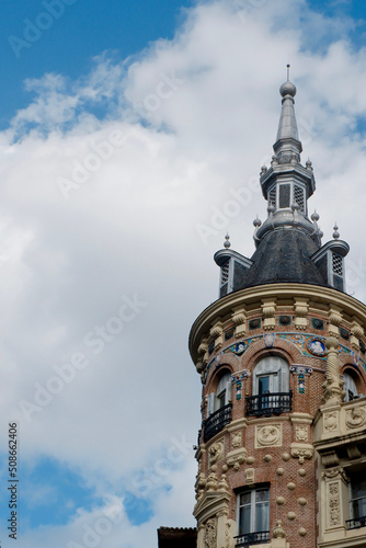 Vintage tower with details in art deco style against blue sky in central district of Madrid, Spain. Vertical photo with copy space