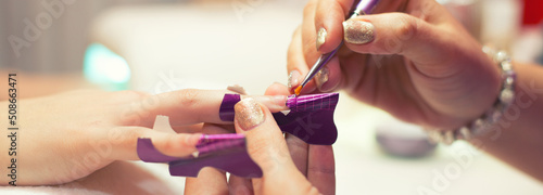 Fotografie Manicure process in beauty salon, making of artificial nails