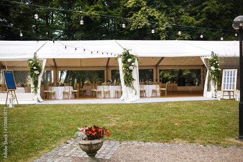 Long white tent for wedding party in the wood