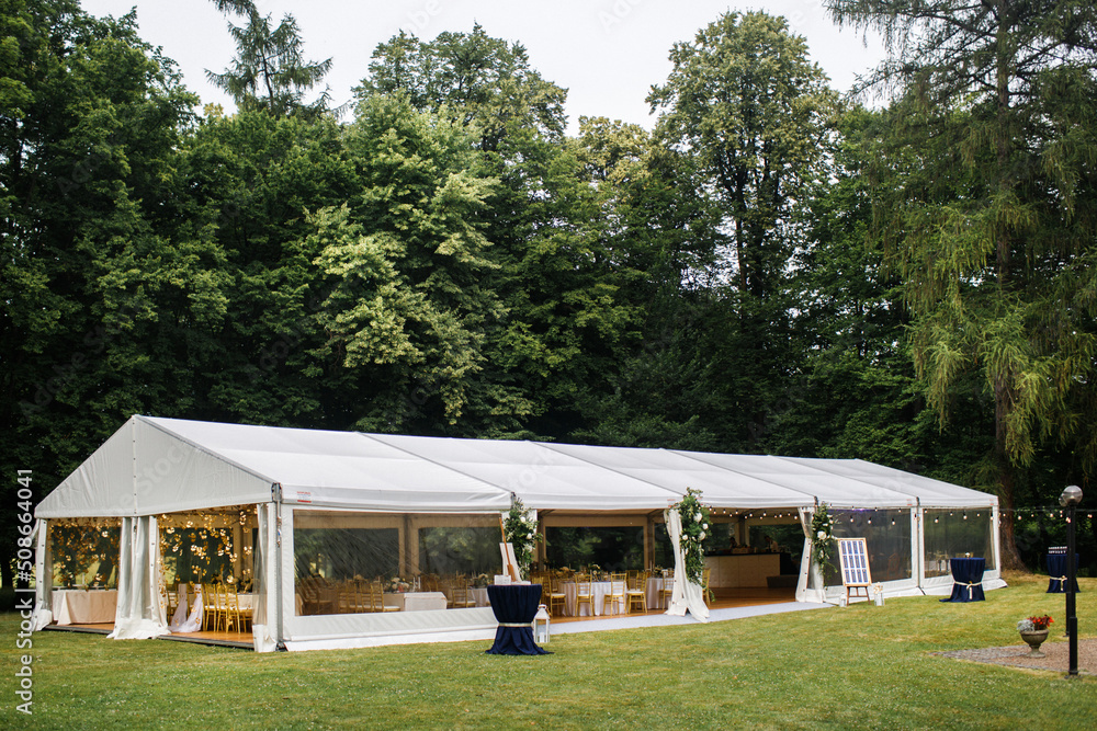 Long white tent for wedding party in the wood - obrazy, fototapety, plakaty 